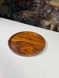 Non-stick perforated pizza pan with raised edges on a kitchen counter

